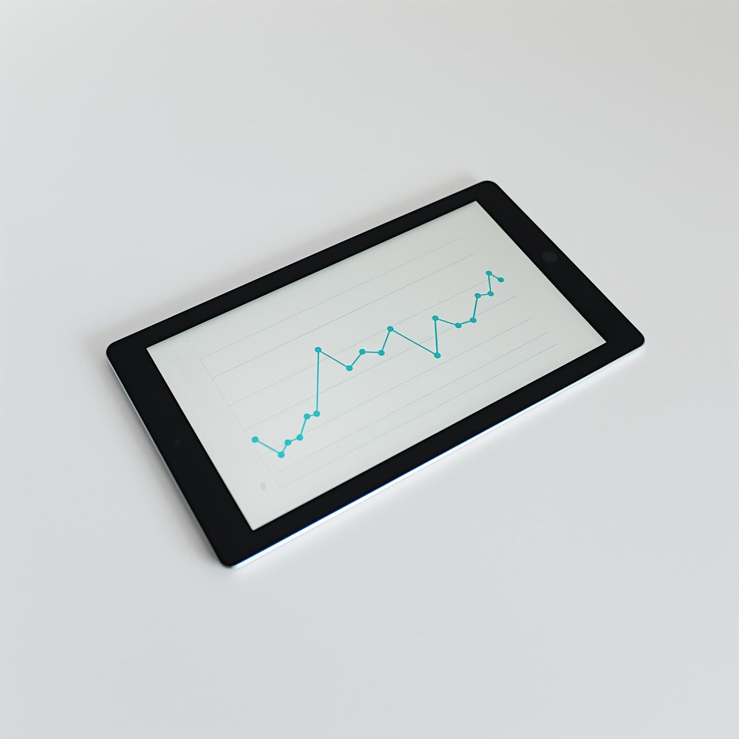 An Example product tablet rests on a white surface, showing a grid-backed line graph with blue data points connected by lines, illustrating fluctuating values.